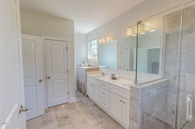 a bathroom with a tub sink and mirror