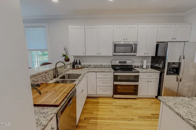 a kitchen with granite countertop cabinets and steel stainless steel appliances