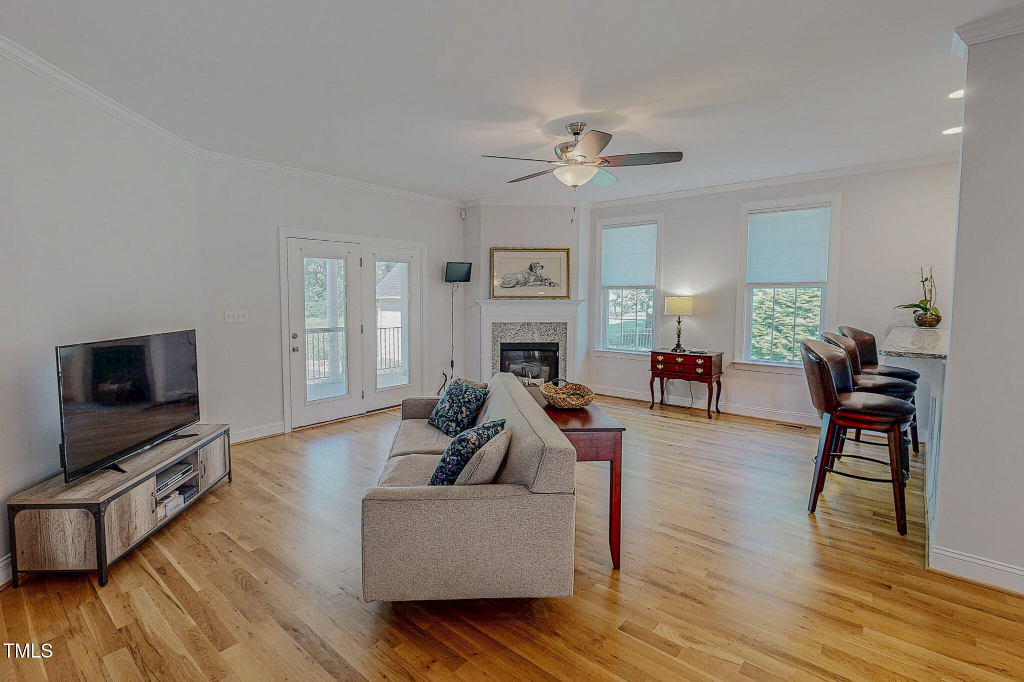 90 South Old Lantern Road Timberlake, NC 27583 - Photo 3 of 63 a living room with furniture a flat screen tv and wooden floor