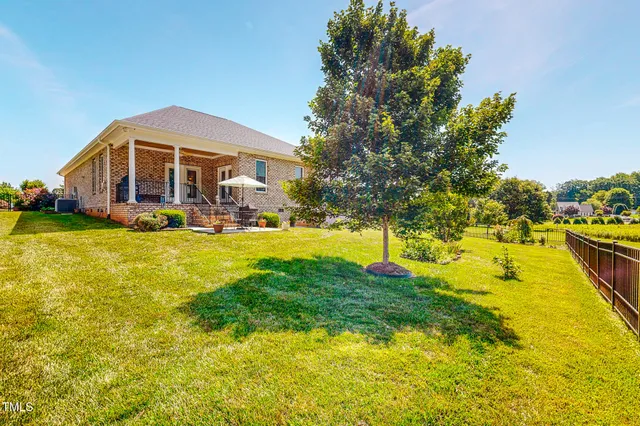 a view of a house with swimming pool and yard