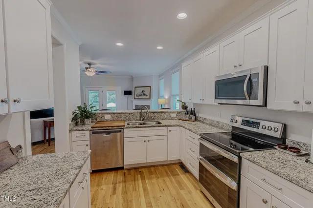a kitchen with a sink stove and microwave