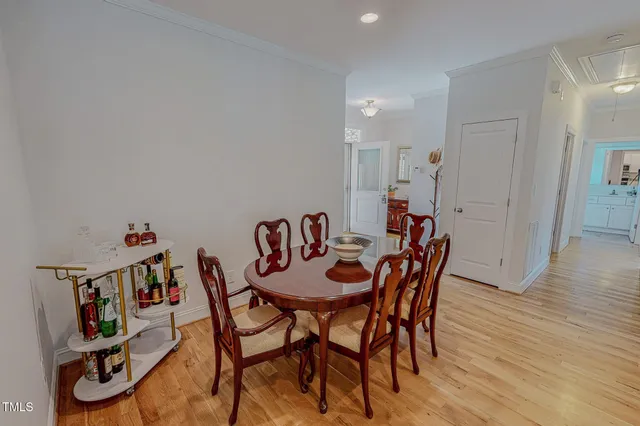 a dining room with furniture and wooden floor