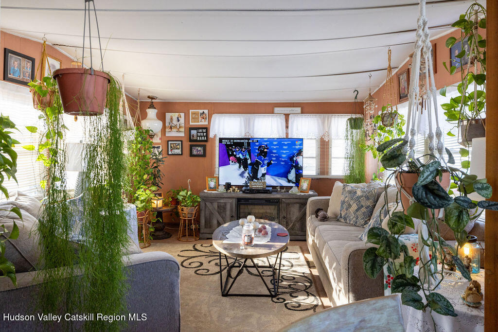 157 Simons Road Ancram, NY 12502 - Photo 9 of 17 a living room with furniture and a flat screen tv
