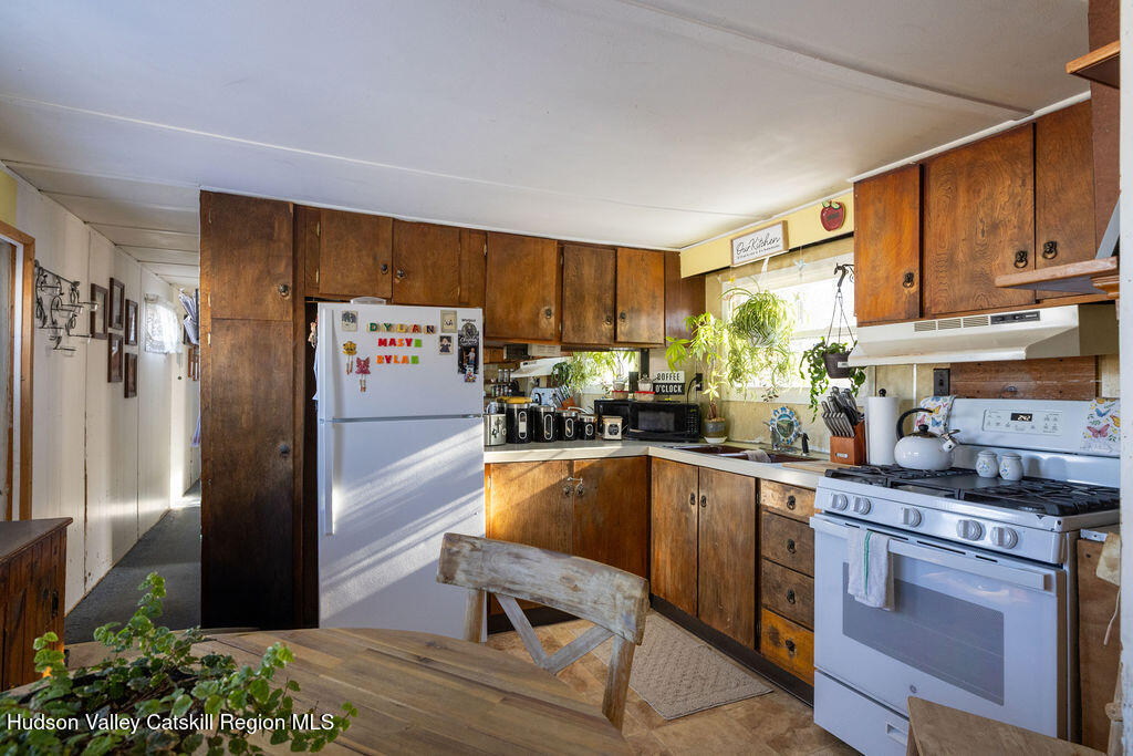 157 Simons Road Ancram, NY 12502 - Photo 9 of 16 a kitchen with stainless steel appliances granite countertop a refrigerator sink and stove