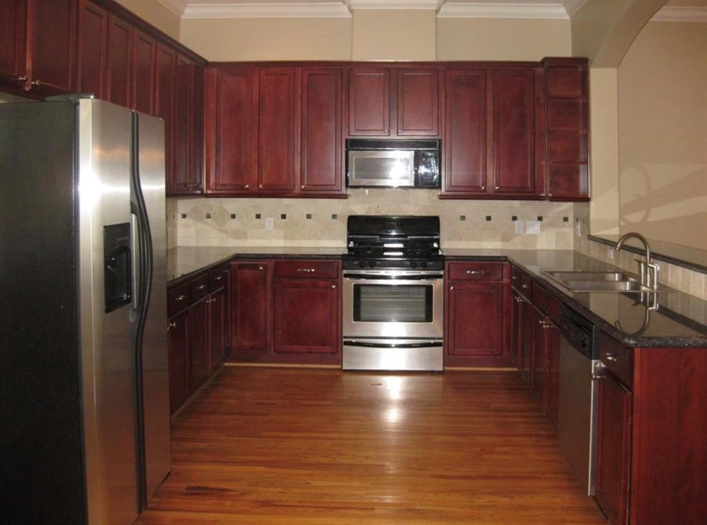 1623 Stuart Street Houston, TX 77004 - Photo 11 of 24 Gourmet kitchen has stainless steel appliances including the refrigerator. Gas stove, microwave, Dishwasher, Cherry cabinets, Granite counters, under cabinet lighting