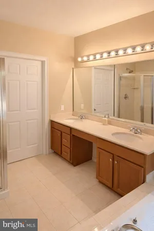 a bathroom with a tub sink and mirror