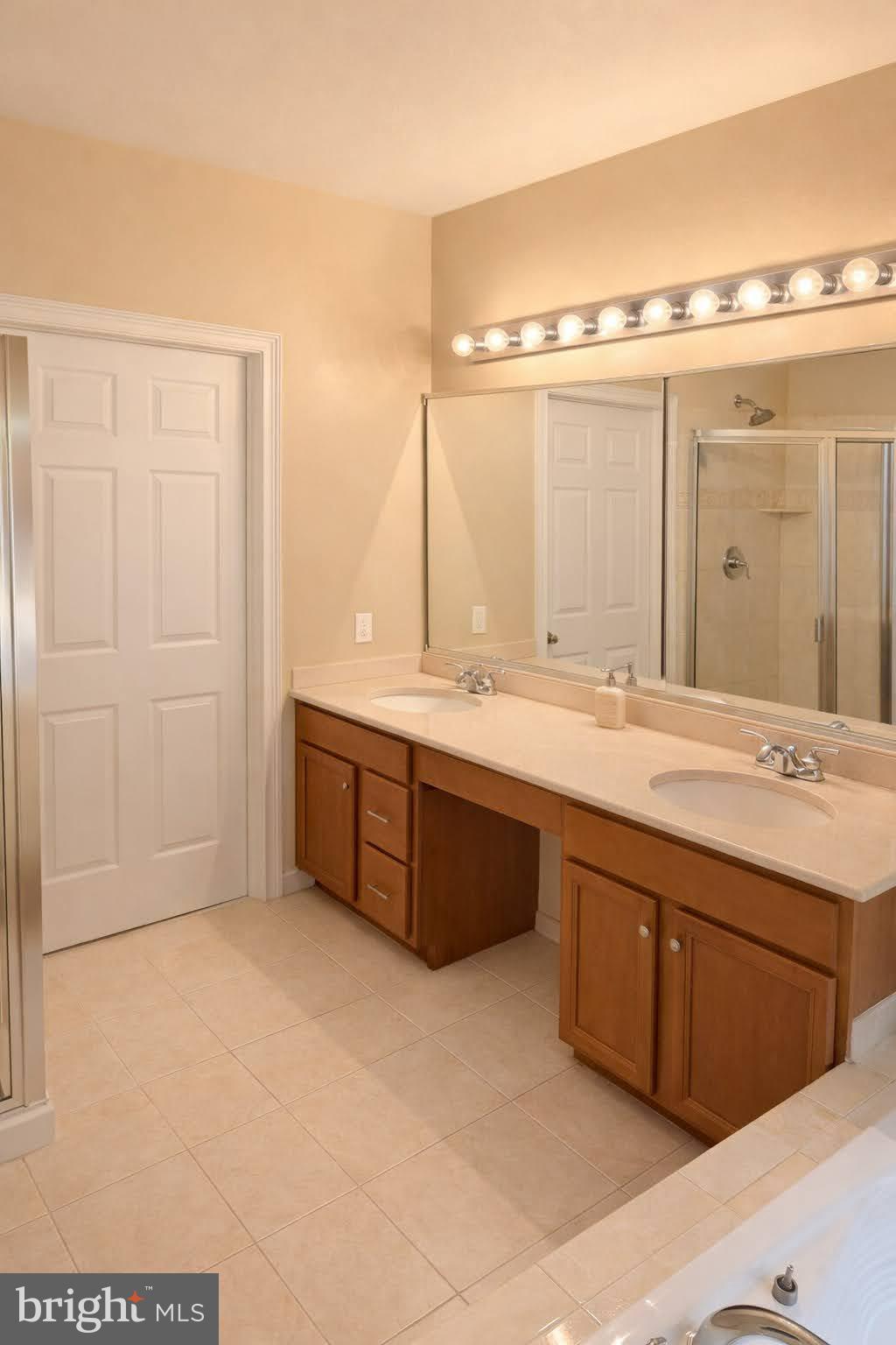 49 Sloan Road West Chester, PA 19382 - Photo 13 of 24 a bathroom with a tub sink and mirror
