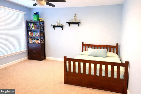 a bed sitting in a bedroom next to a window
