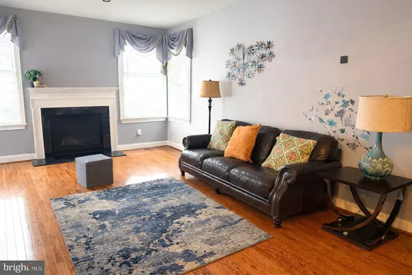 a living room with furniture fireplace and a flat screen tv
