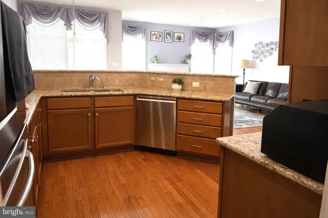 a view of a kitchen with a sink and wooden floor
