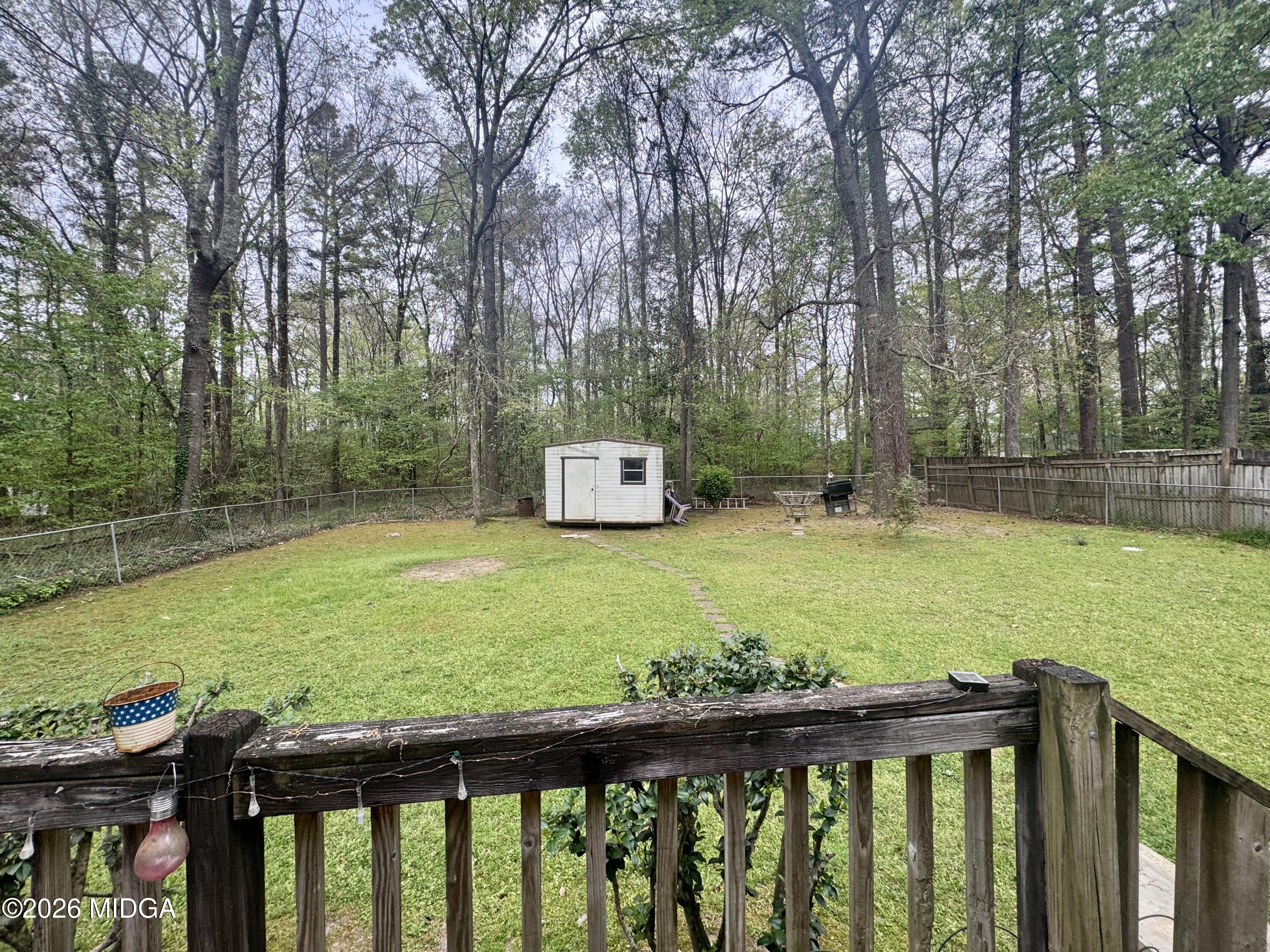682 Wilderness Drive Macon, GA 31220 - Photo 14 of 25 a view of a deck with a trees in the background