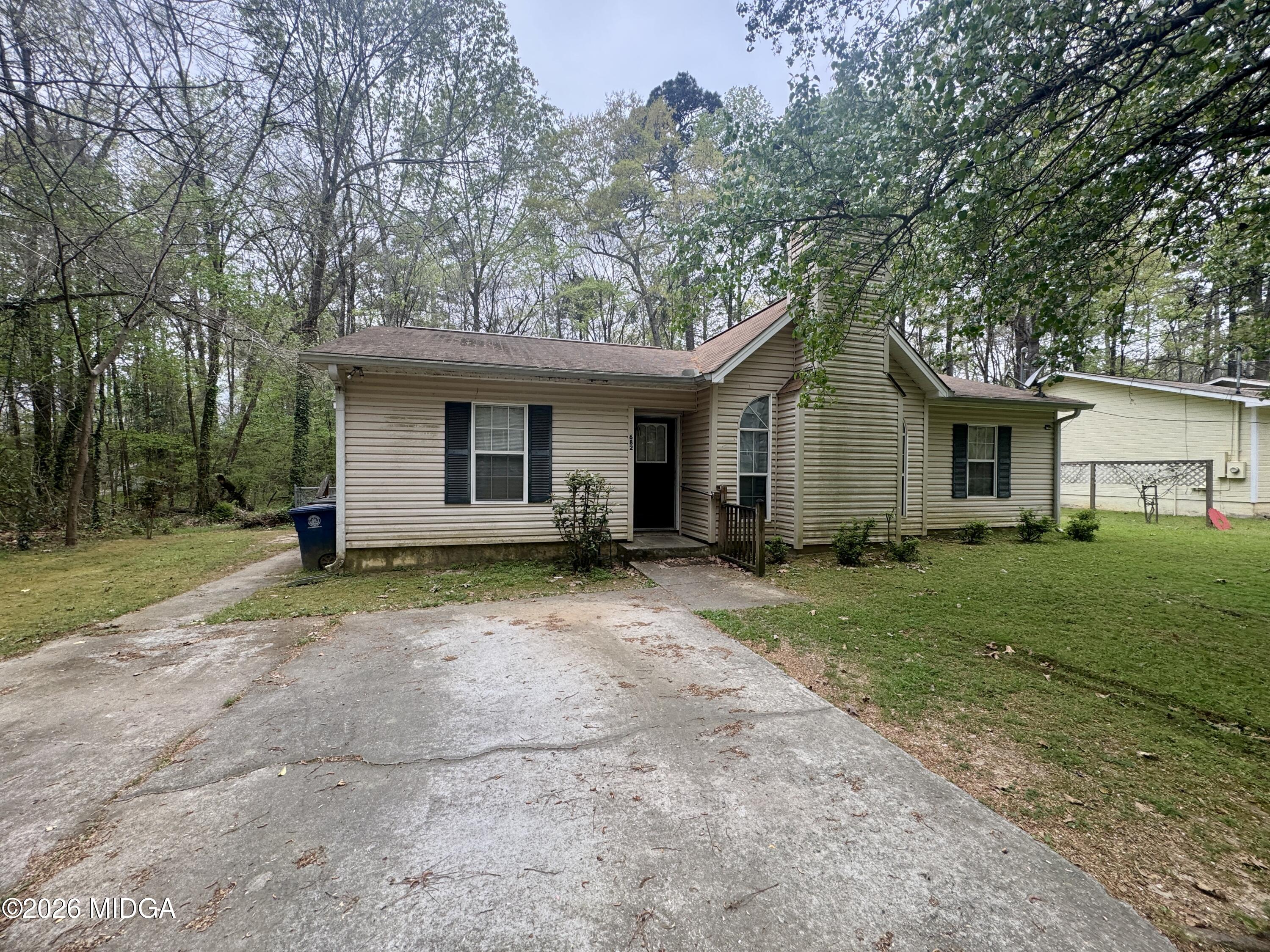 682 Wilderness Drive Macon, GA 31220 - Photo 15 of 25 a view of a yard in front of a house with large trees