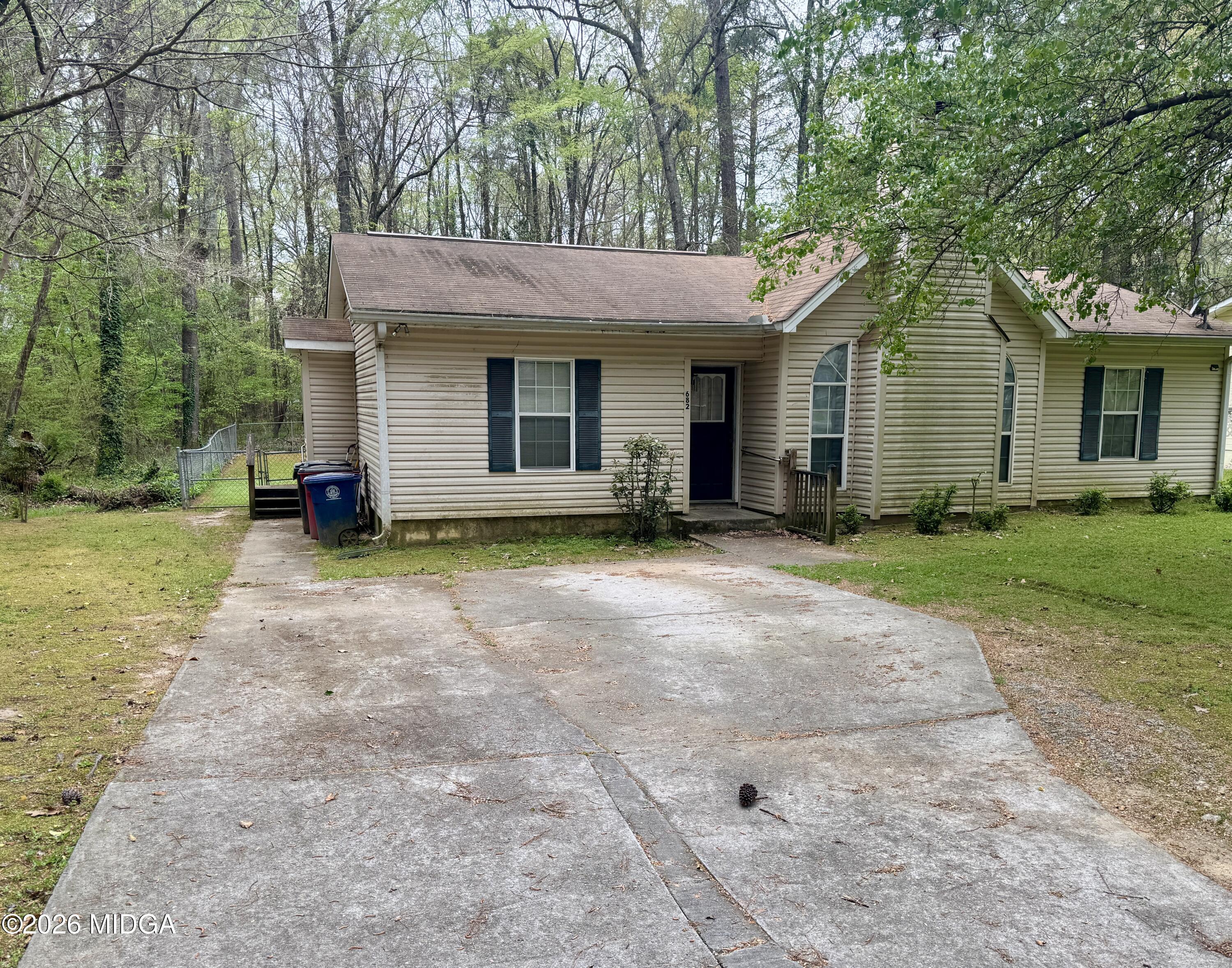 682 Wilderness Drive Macon, GA 31220 - Photo 18 of 25 a front view of a house with a yard and trees