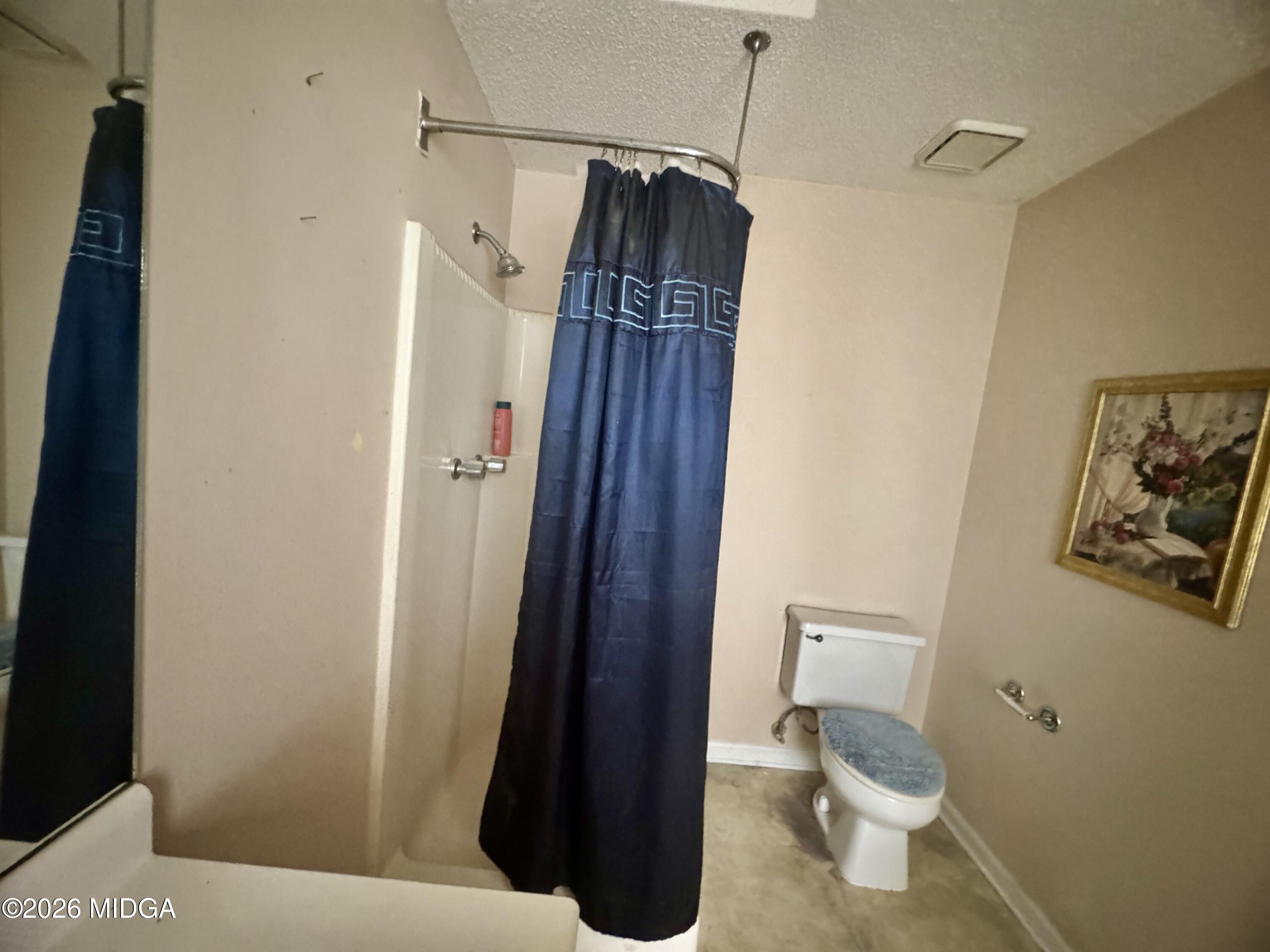 682 Wilderness Drive Macon, GA 31220 - Photo 7 of 25 a bathroom with a toilet and a shower
