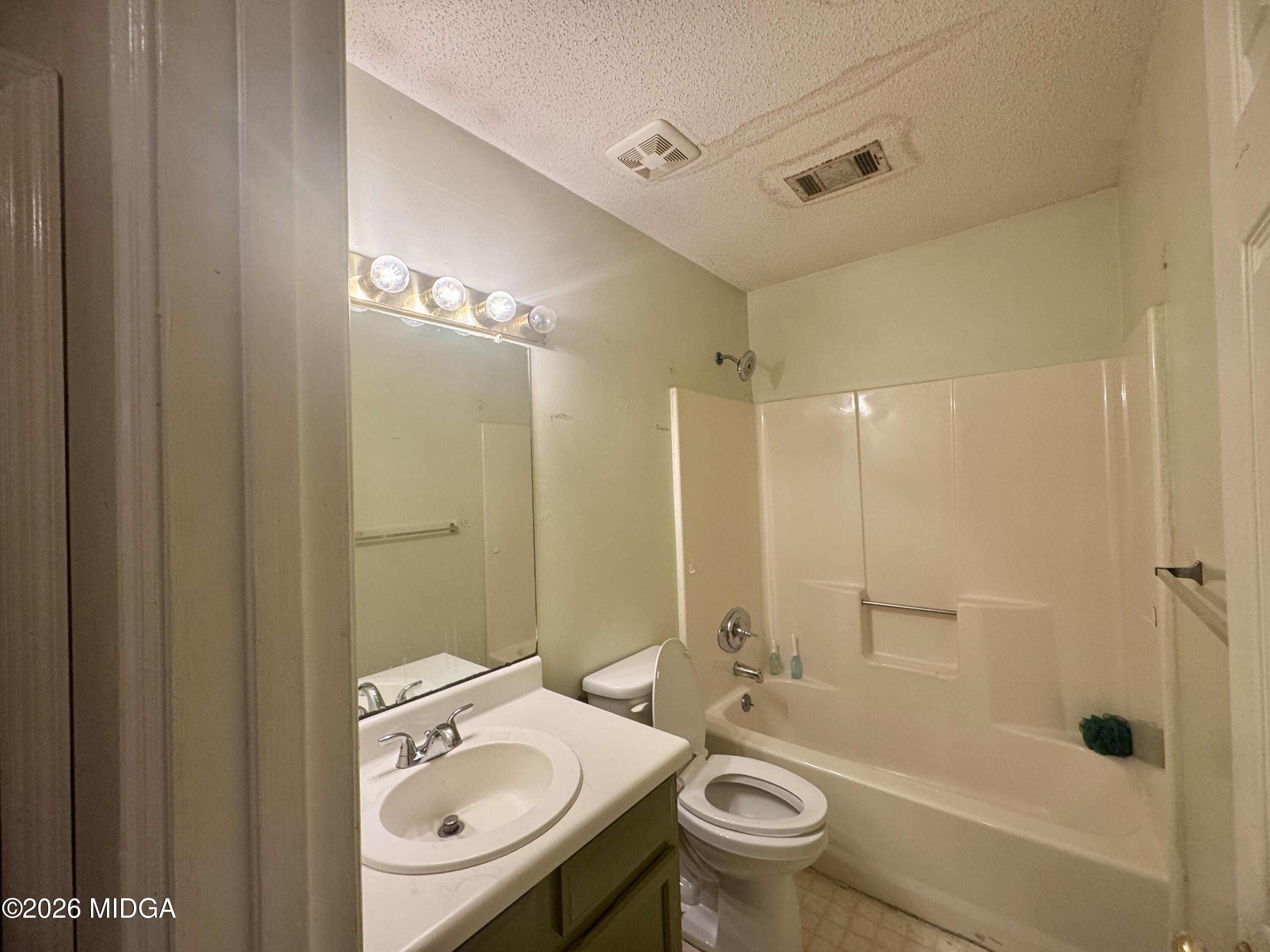 682 Wilderness Drive Macon, GA 31220 - Photo 9 of 25 a bathroom with a granite countertop sink a toilet and shower