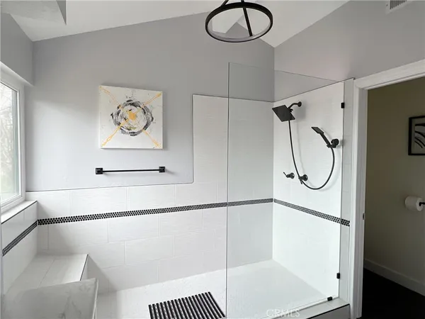 a bathroom with a bathtub and a shower