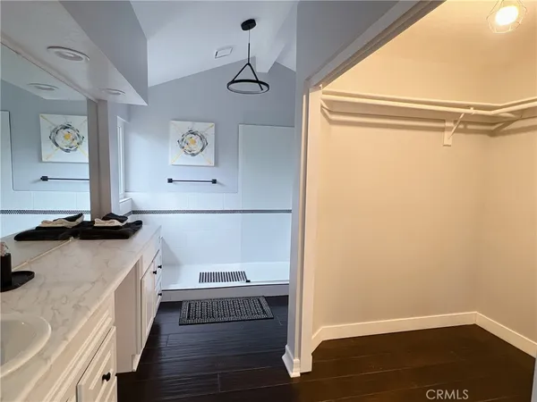 a hallway with a large window and wooden floor
