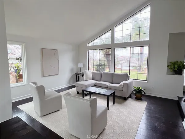 a living room with furniture and floor to ceiling windows