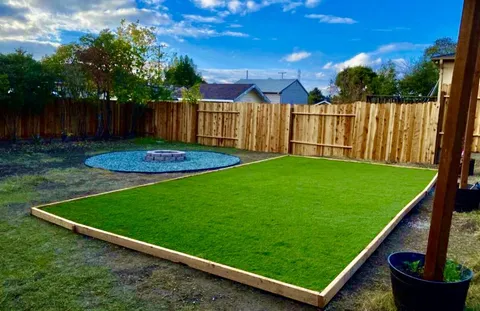 a view of a backyard with wooden fence