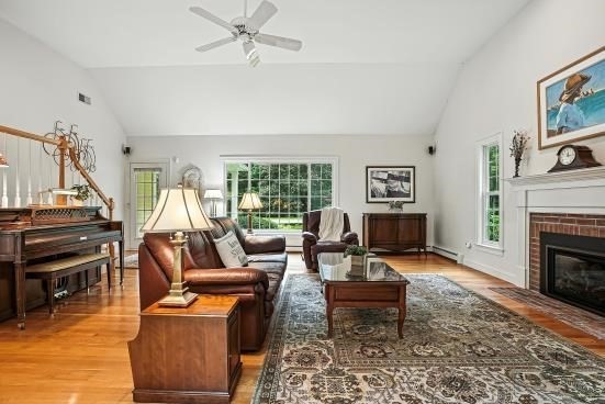 8 Miscoe Hill Road Upton, MA 01568 - Photo 19 of 40 a living room with furniture a fireplace and a flat screen tv