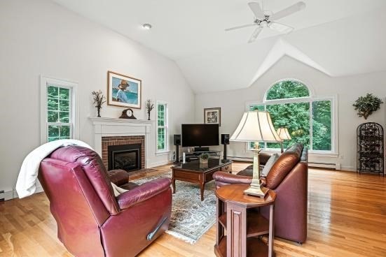 8 Miscoe Hill Road Upton, MA 01568 - Photo 22 of 40 a living room with furniture a fireplace and a floor to ceiling window
