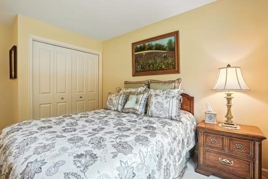 8 Miscoe Hill Road Upton, MA 01568 - Photo 26 of 40 a bedroom with a bed and a lamp on dresser