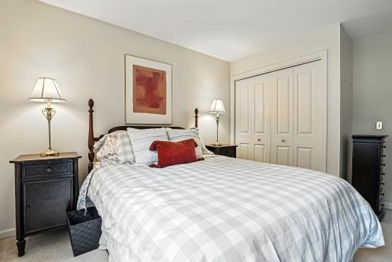 8 Miscoe Hill Road Upton, MA 01568 - Photo 27 of 40 a bedroom with a bed and a lamp