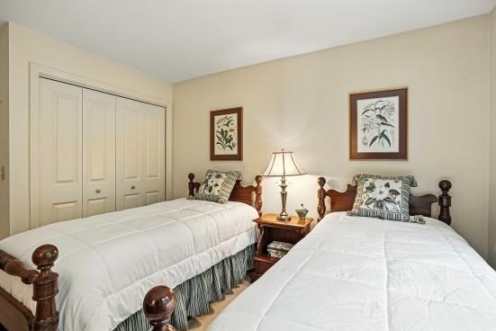 8 Miscoe Hill Road Upton, MA 01568 - Photo 28 of 40 a bedroom with two beds and a lamp on dresser