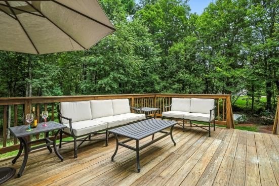 8 Miscoe Hill Road Upton, MA 01568 - Photo 39 of 40 a roof deck with table and chairs under an umbrella
