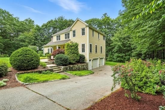 8 Miscoe Hill Road Upton, MA 01568 - Photo 40 of 40 a front view of a house with a yard and potted plants