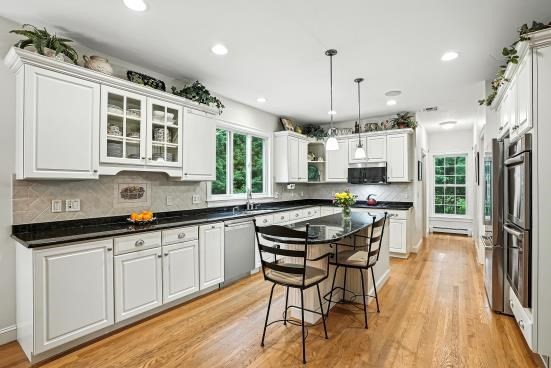 8 Miscoe Hill Road Upton, MA 01568 - Photo 9 of 40 a kitchen with stainless steel appliances kitchen island granite countertop a table chairs stove and cabinets