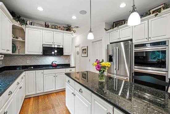 8 Miscoe Hill Road Upton, MA 01568 - Photo 10 of 40 a kitchen with stainless steel appliances granite countertop a sink a stove and a refrigerator