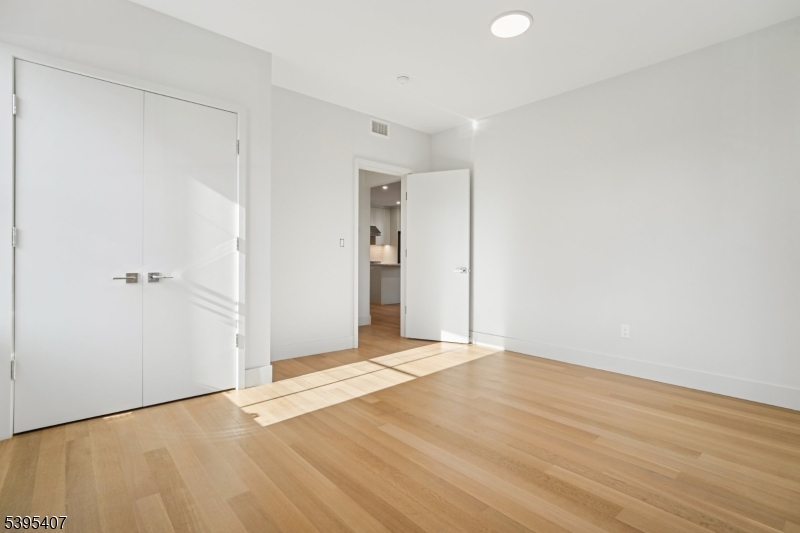 75 Midland Avenue, Unit 2 Montclair, NJ 07042 - Photo 12 of 18 a view of an empty room with wooden floor