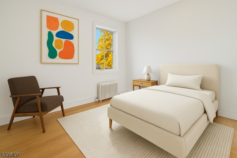 75 Midland Avenue, Unit 2 Montclair, NJ 07042 - Photo 14 of 18 a bedroom with a bed and a chair