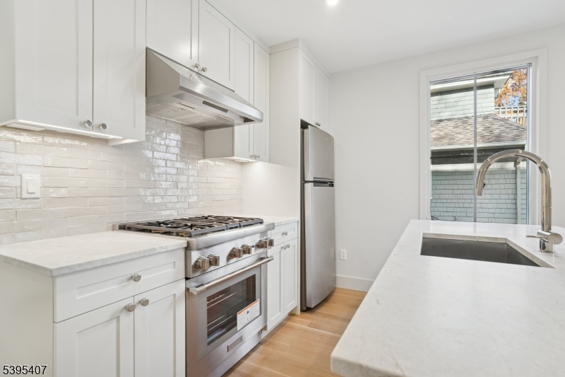 75 Midland Avenue, Unit 2 Montclair, NJ 07042 - Photo 6 of 18 a kitchen with a stove a sink and a refrigerator