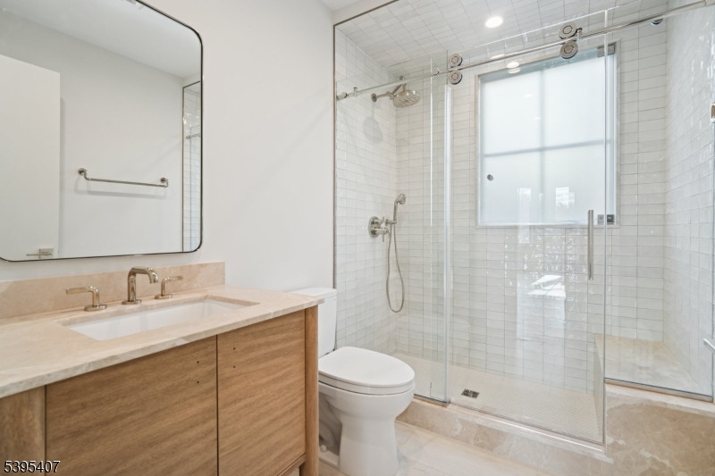 75 Midland Avenue, Unit 2 Montclair, NJ 07042 - Photo 9 of 18 a bathroom with a sink a toilet and shower