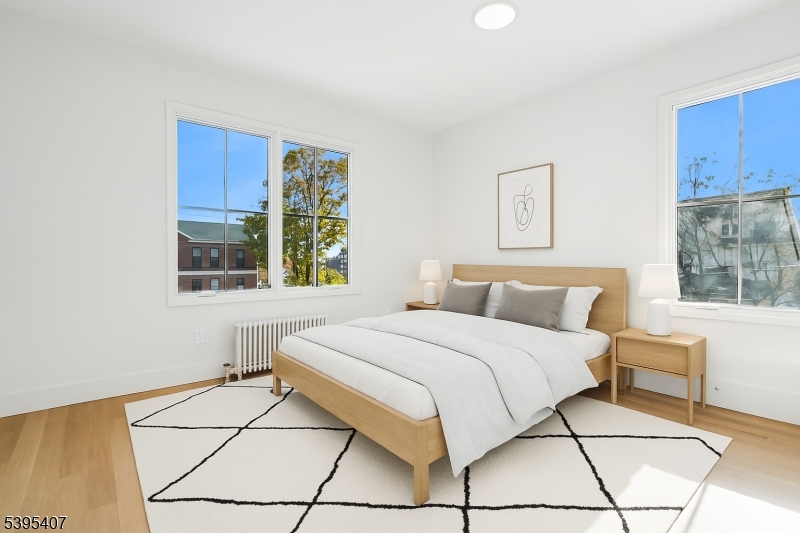 75 Midland Avenue, Unit 2 Montclair, NJ 07042 - Photo 10 of 18 a bedroom with a bed and a window