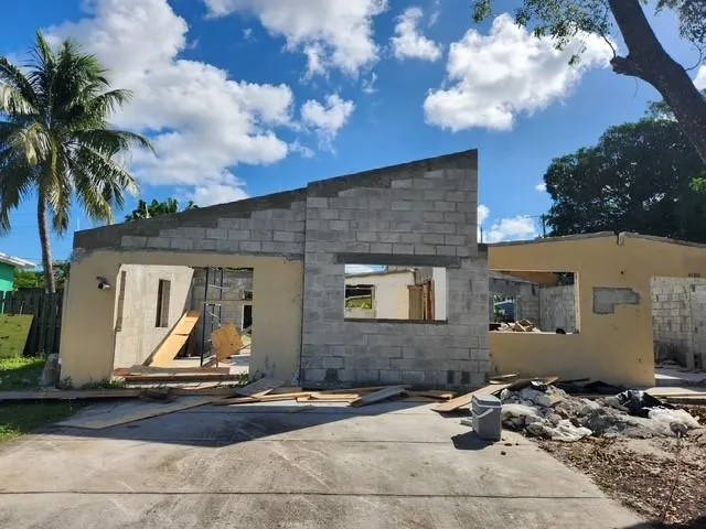 a front view of a house with sitting area