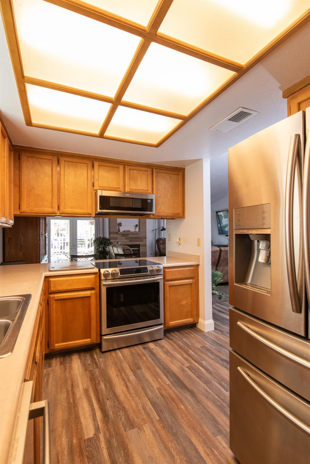 301 Goldrun Drive Modesto, CA 95354 - Photo 7 of 20 a kitchen with stainless steel appliances granite countertop a sink a stove top oven and cabinetry