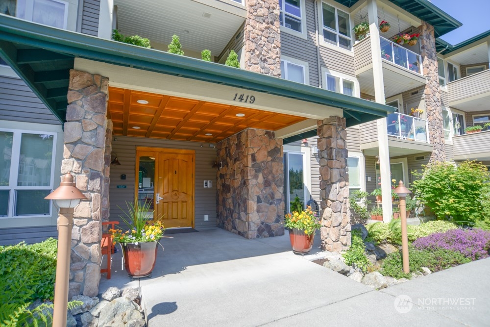 1419 Digby Place, Unit 309 Mount Vernon, WA 98274 - Photo 1 of 34 a view of a building with potted plants
