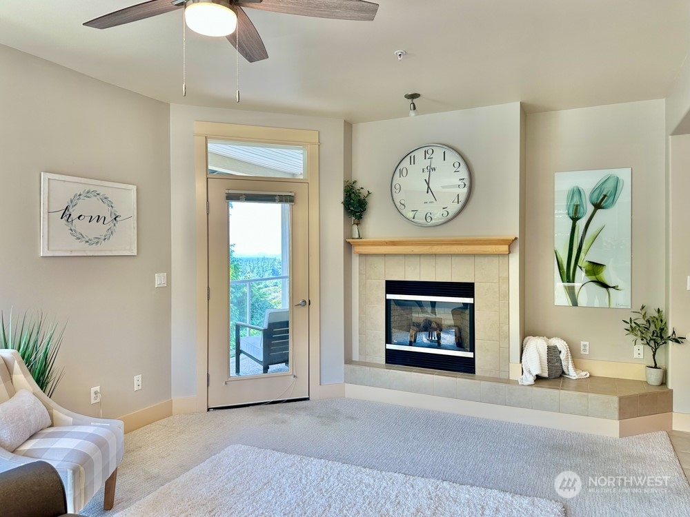 1419 Digby Place, Unit 309 Mount Vernon, WA 98274 - Photo 11 of 34 a living room with furniture a clock and a fireplace