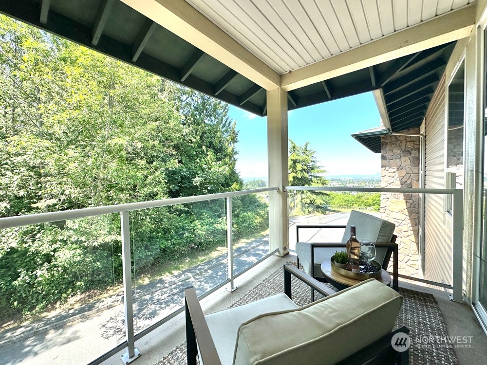 1419 Digby Place, Unit 309 Mount Vernon, WA 98274 - Photo 18 of 34 a balcony with wooden floor and outdoor seating