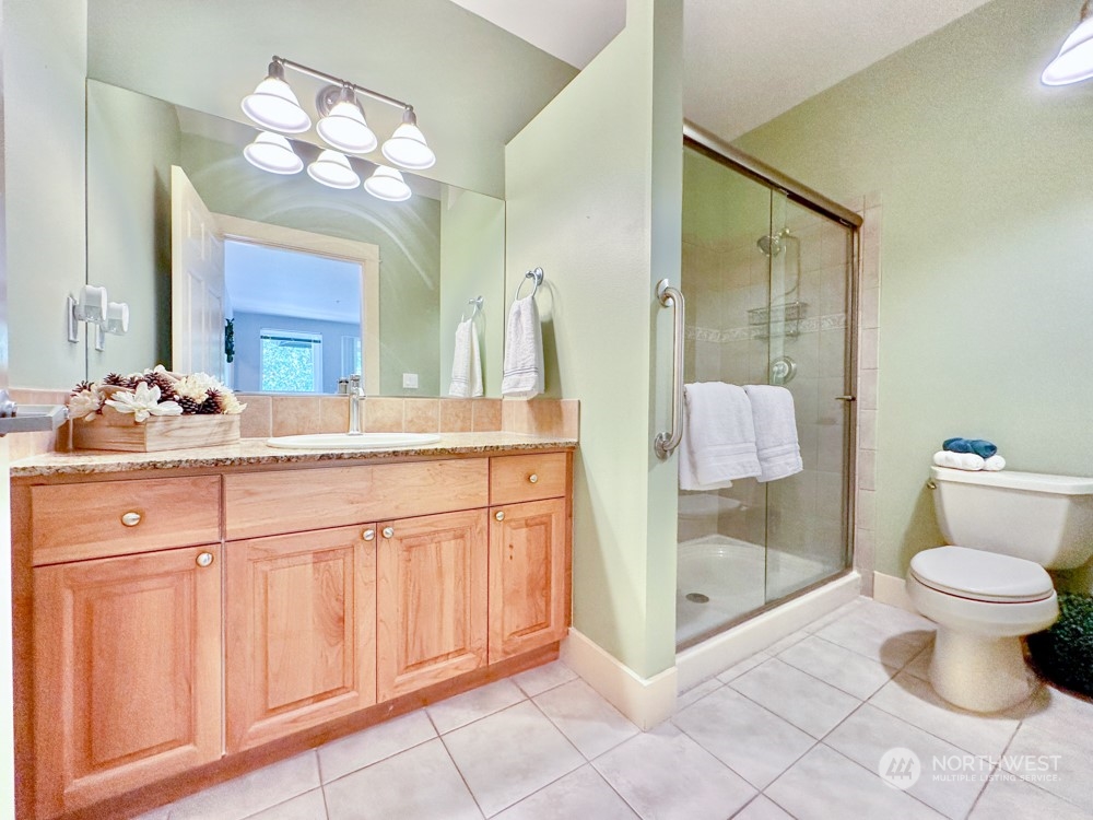 1419 Digby Place, Unit 309 Mount Vernon, WA 98274 - Photo 22 of 34 a bathroom with a sink vanity mirror and toilet