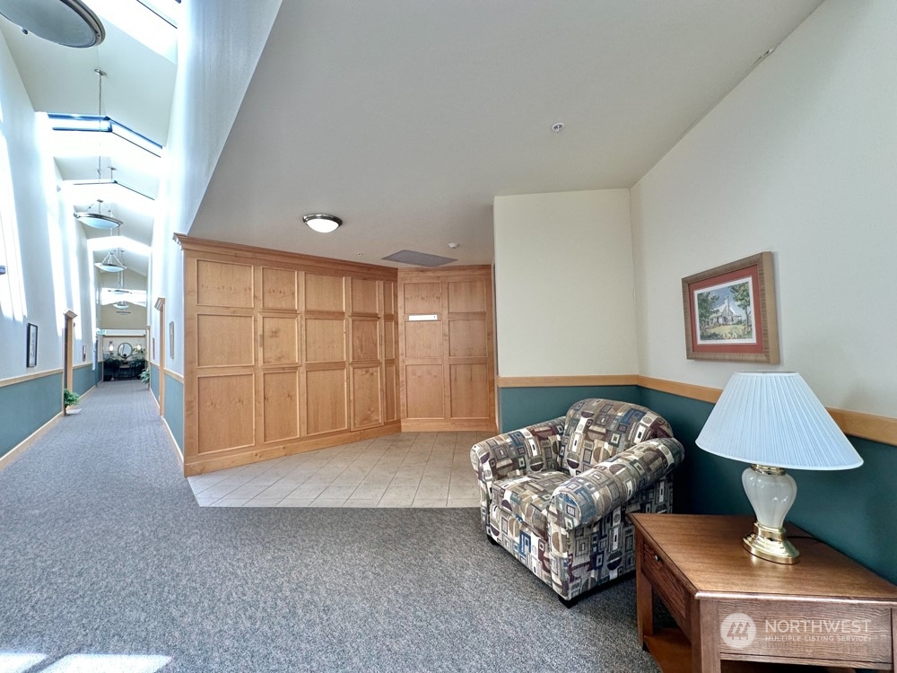 1419 Digby Place, Unit 309 Mount Vernon, WA 98274 - Photo 28 of 34 a spacious bedroom with a bed and a couch