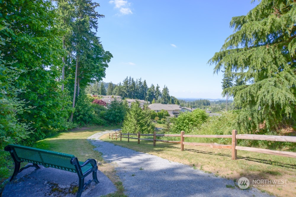 1419 Digby Place, Unit 309 Mount Vernon, WA 98274 - Photo 31 of 34 a view of a swimming pool with lawn chairs under an umbrella