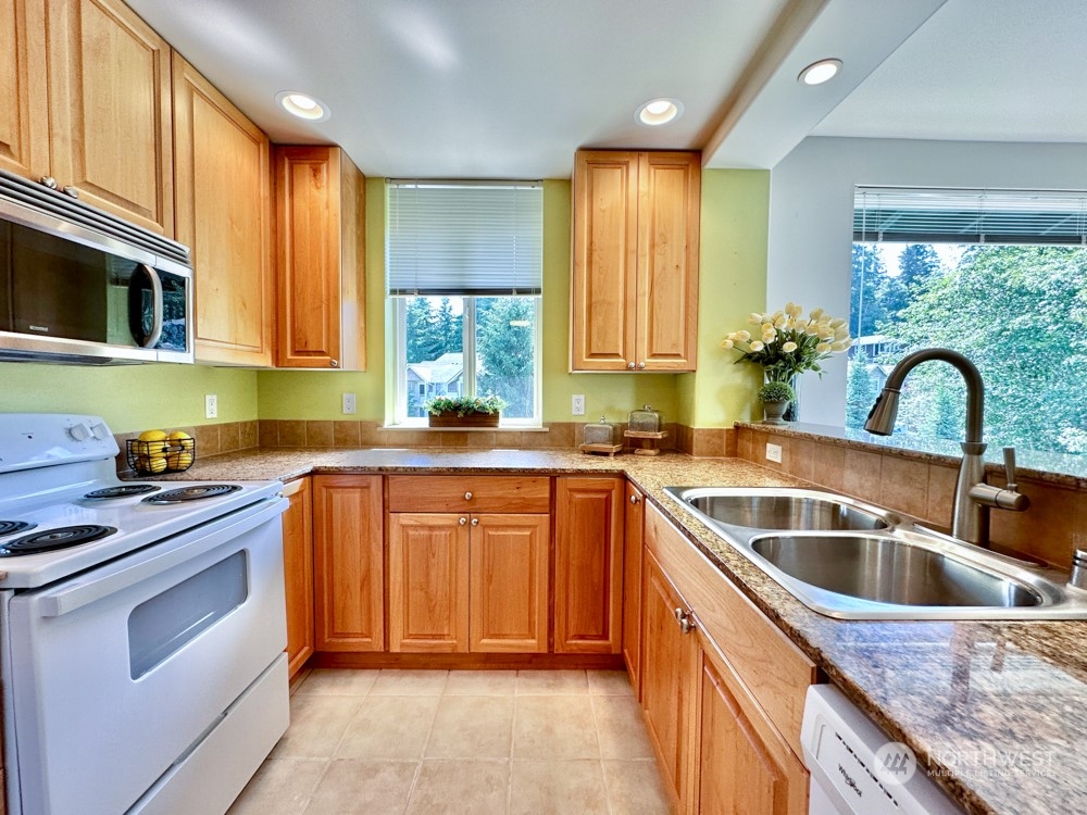 1419 Digby Place, Unit 309 Mount Vernon, WA 98274 - Photo 6 of 34 a kitchen with granite countertop a sink and counter space