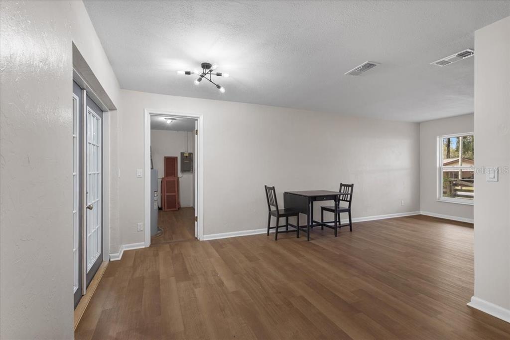 1315 Southwest 252nd Street Newberry, FL 32669 - Photo 11 of 29 a view of a dining room with furniture and a chandelier