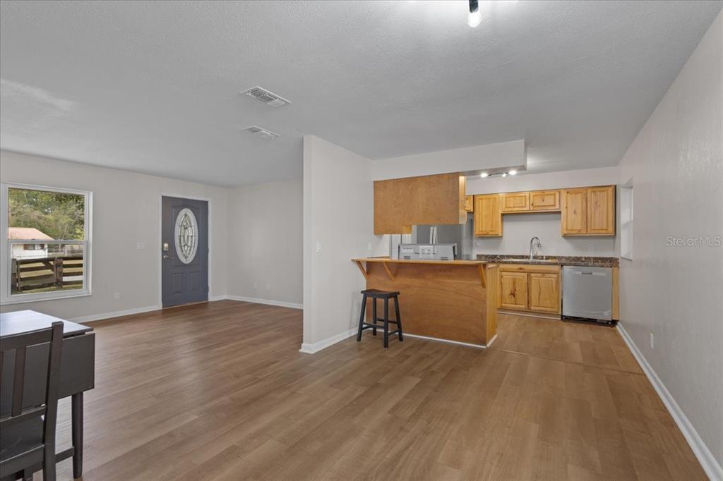 1315 Southwest 252nd Street Newberry, FL 32669 - Photo 13 of 29 a view of a kitchen with wooden floor and a sink