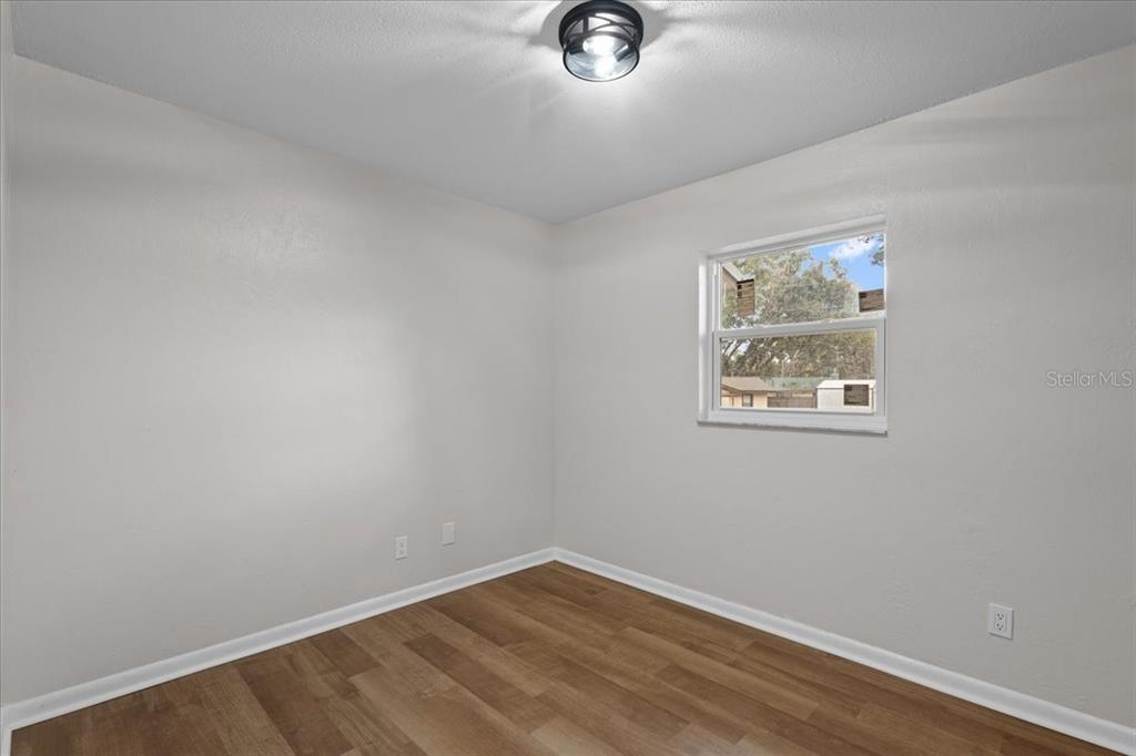 1315 Southwest 252nd Street Newberry, FL 32669 - Photo 14 of 29 an empty room with a wooden door and white walls