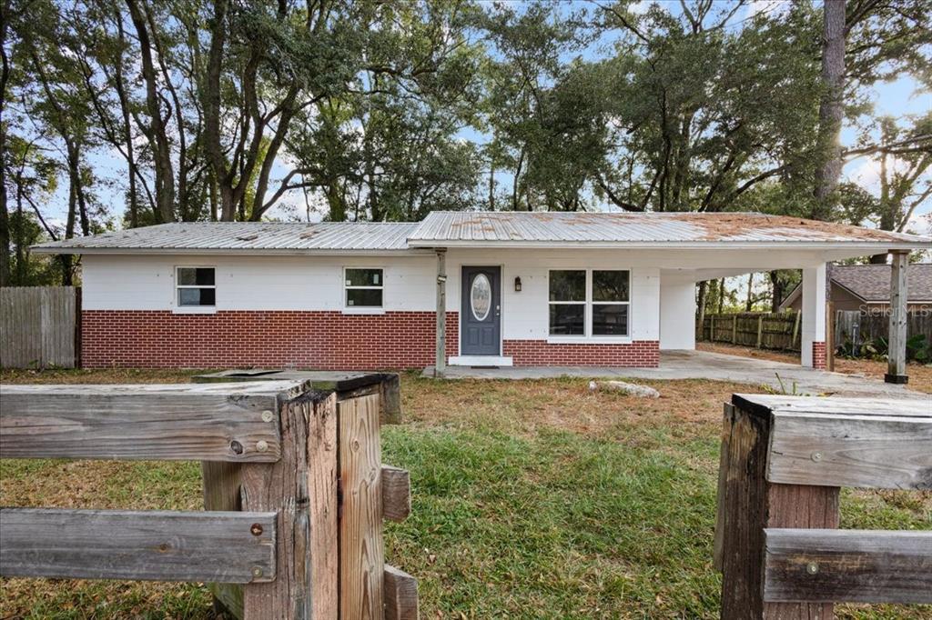 1315 Southwest 252nd Street Newberry, FL 32669 - Photo 2 of 29 front view of house with a yard